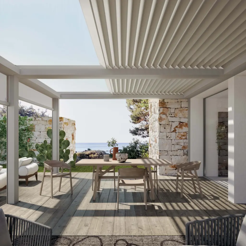 Pergola mit Lamellendach über einer Terrasse mit Essbereich und Meerblick