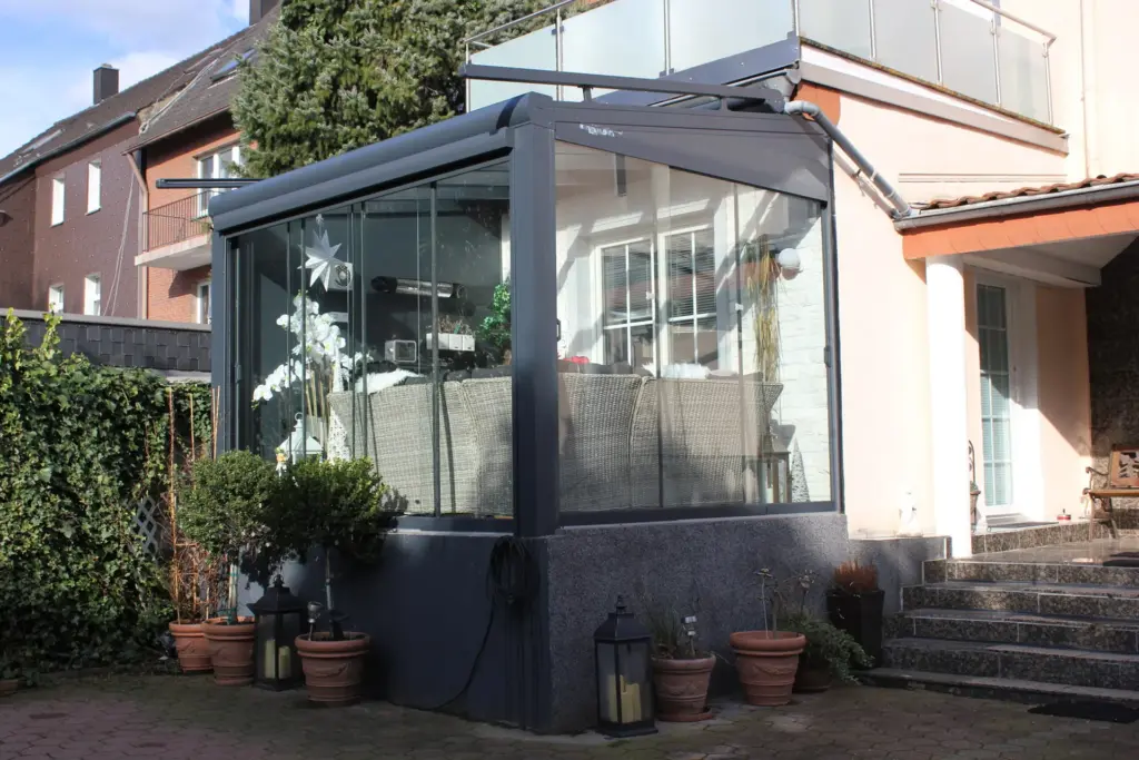 Kompakter Kaltwintergarten mit Glas-Schiebeanlage und Aluminiumrahmen an Terrasse
