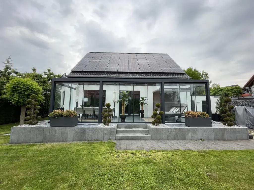 Kaltwintergarten mit Glas-Schiebeelementen und Aluminiumrahmen am Einfamilienhaus